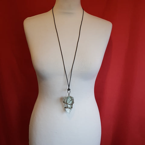 Transparent pendant in a metallic casing with a black leather cord, without a clasp